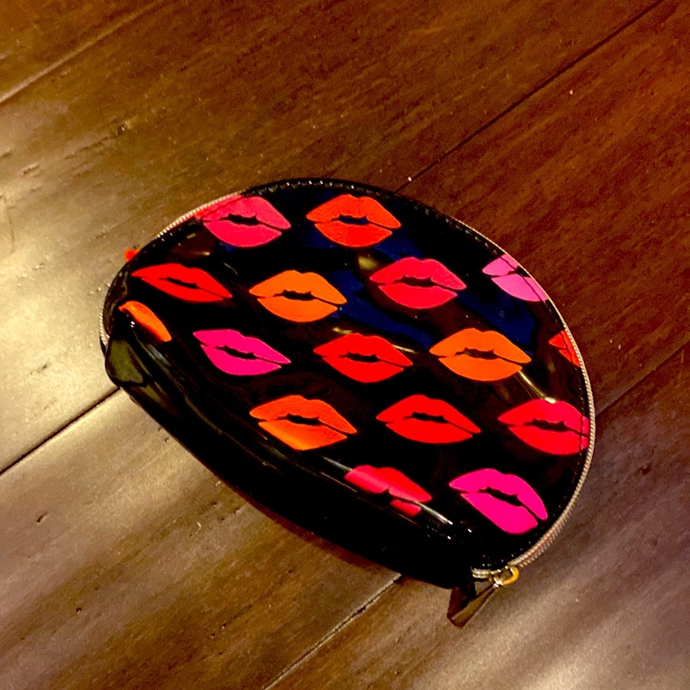 Small black makeup back with lip kiss print.